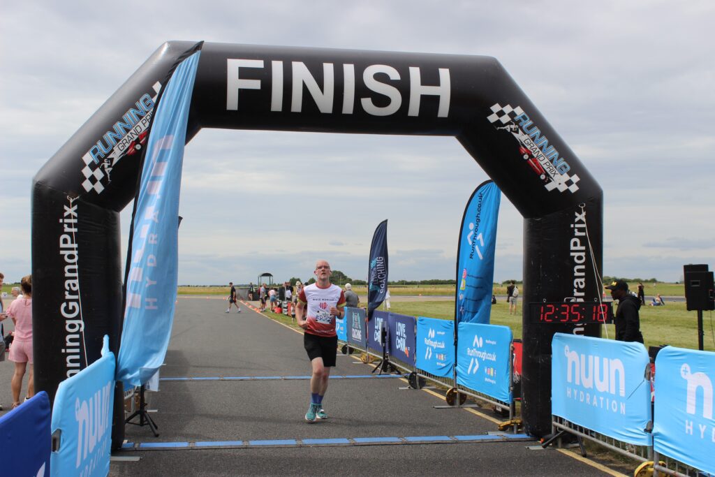 A photo of me crossing the finish line. Annoyingly the photographer missed my grand gesture of elation as I crossed it.